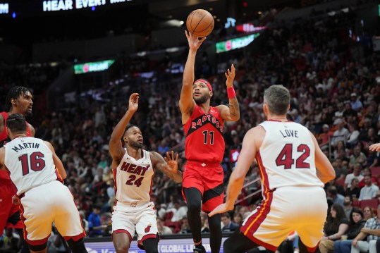 Apr 12, 2024; Miami, Florida, USA;  Toronto Raptors forward Bruce Brown (11) lobs a pass toward the basket as Miami Heat forward Haywood Highsmith (24) and forward Kevin Love (42) defend during the second half at Kaseya Center. Mandatory Credit: Jim Rassol-USA TODAY Sports