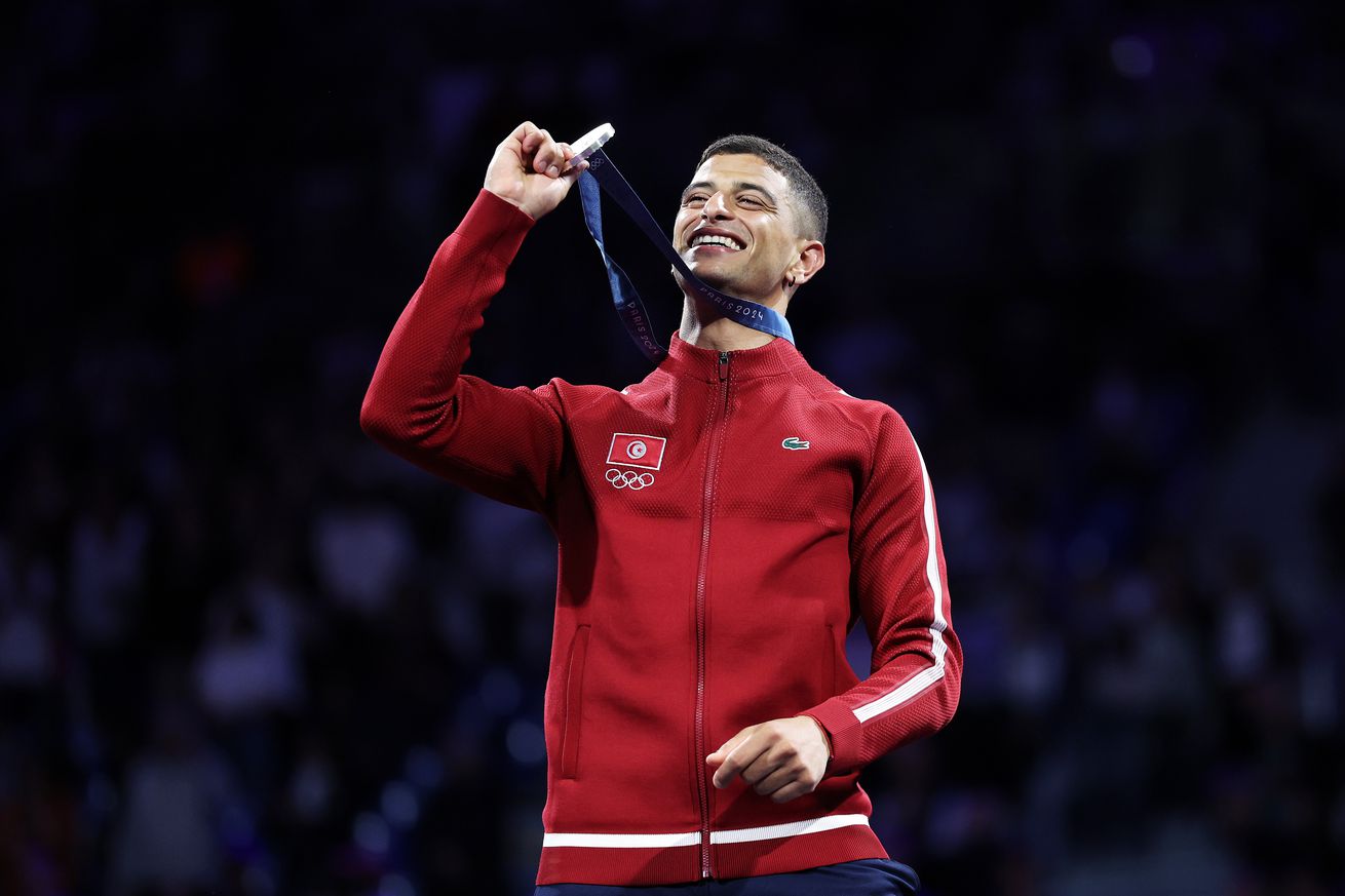 Silver medalist Fares Ferjani of Team Tunisia celebrates on the podium during the Men’s Sabre Individual medal ceremony on day one of the Olympic Games Paris 2024 at Grand Palais on July 27, 2024 in Paris, France.