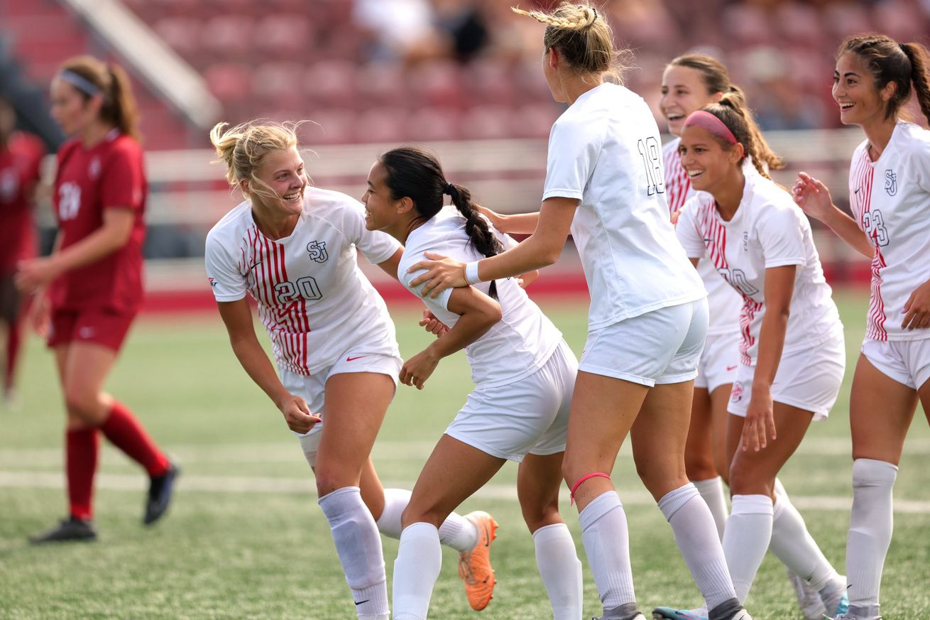 The St. John’s Red Storm women’s soccer team celebrates a goal at Belson Stadium on the campus of St. John’s University in Jamaica, NY. Credit to St. John’s University Athletics.