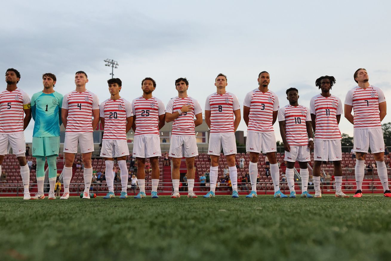 St. John’s Red Storm men’s soccer players standing for the playing of the national anthem prior to kickoff at Belson Stadium on the campus of St. John’s University in Jamaica, New York. Credit to St. John’s University Athletics.