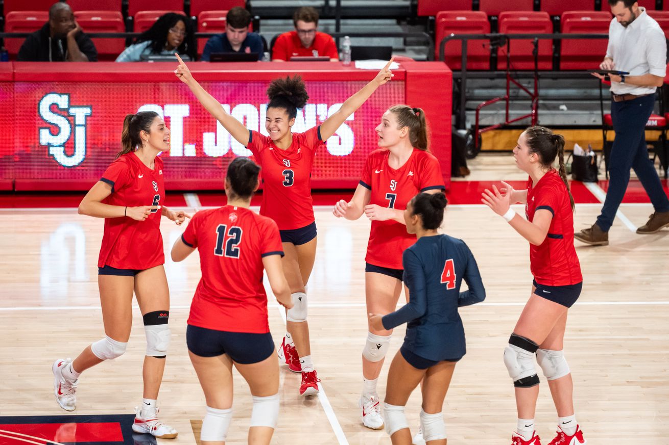 St. John’s Red Storm volleyball team celebrates on the court during a game in Carnesecca Arena on the campus of St. John’s University in Jamaica, Queens, New York