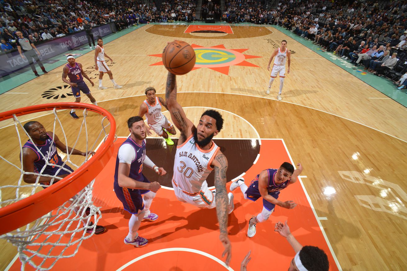  SAN ANTONIO, TX - MARCH 25: Julian Champagnie #30 of the San Antonio Spurs drives to the basket during the game against the Phoenix Suns on March 25, 2024 at the AT&T Center in San Antonio, Texas. NOTE TO USER: User expressly acknowledges and agrees that, by downloading and or using this photograph, user is consenting to the terms and conditions of the Getty Images License Agreement. Mandatory Copyright Notice: Copyright 2024 NBAE