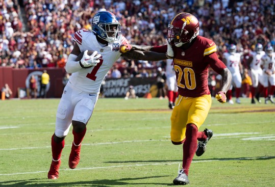 Sep 15, 2024; Landover, Maryland, USA; New York Giants wide receiver Malik Nabers (1) stiff arms Washington Commanders safety Quan Martin (20) in the second half at Commanders Field. Mandatory Credit: Luke Johnson-Imagn Images