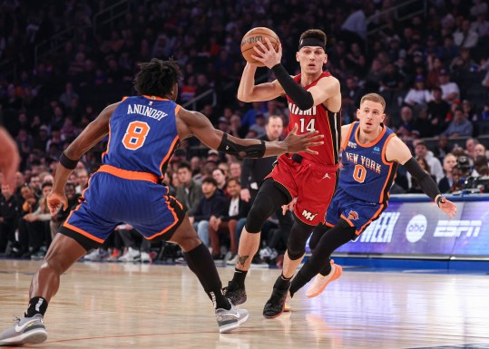 Jan 27, 2024; New York, New York, USA; Miami Heat guard Tyler Herro (14) drives to the basket after the game New York Knicks forward OG Anunoby (8) and guard Donte DiVincenzo (0) during the first half at Madison Square Garden. Mandatory Credit: Vincent Carchietta-Imagn Images