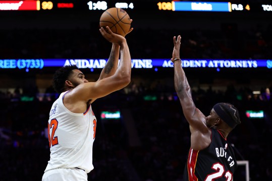 Oct 30, 2024; Miami, Florida, USA; New York Knicks center Karl-Anthony Towns (32) shoots the basketball over Miami Heat forward Jimmy Butler (22) during the fourth quarter at Kaseya Center. Mandatory Credit: Sam Navarro-Imagn Images