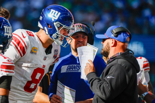 Oct 6, 2024; Seattle, Washington, USA; New York Giants quarterback Daniel Jones (8) talks with head coach Brian Daboll, right) during the second quarter against the Seattle Seahawks at Lumen Field. New York Giants quarterbacks coach Shea Tierney stands in the middle. Mandatory Credit: Joe Nicholson-Imagn Images