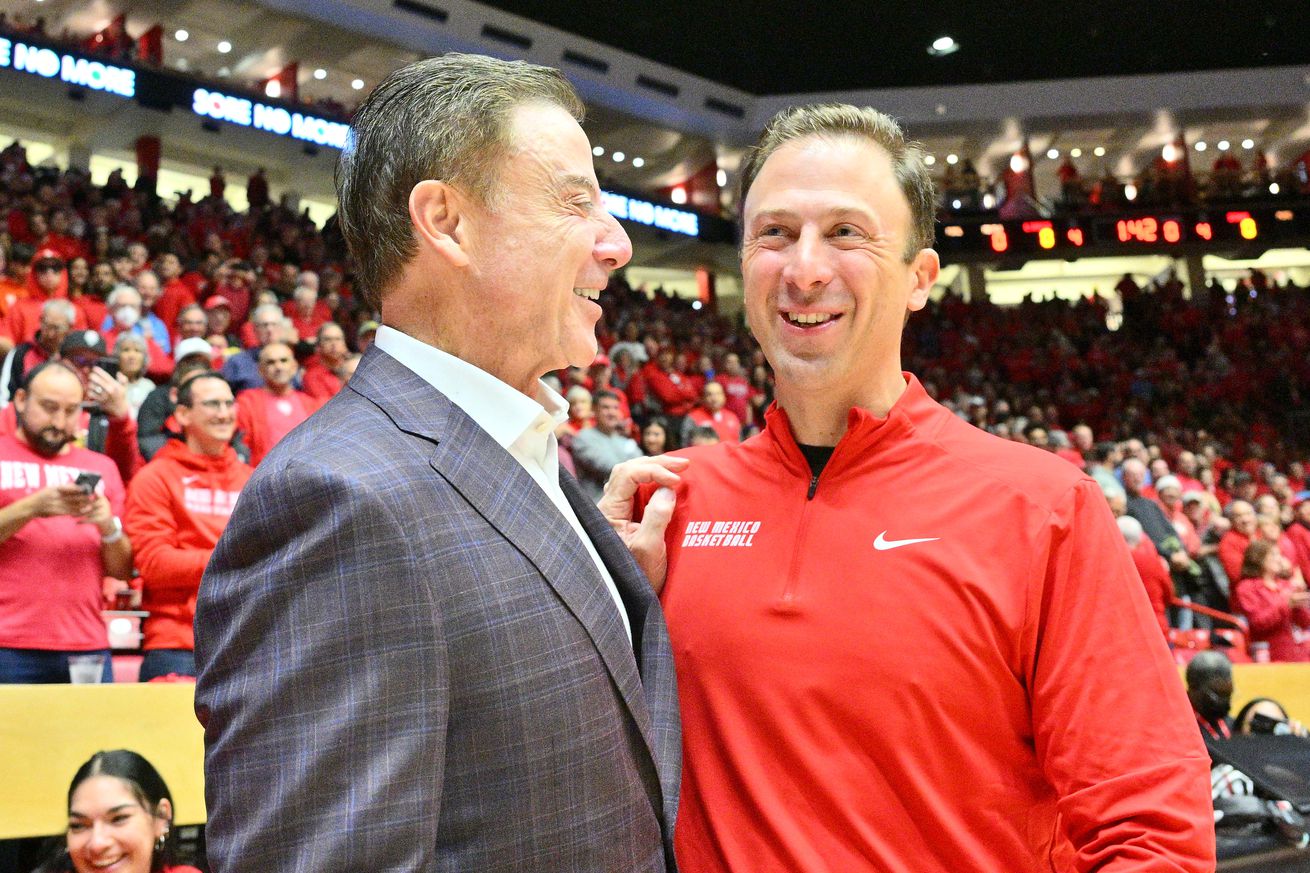 ALBUQUERQUE, NEW MEXICO - DECEMBER 18: Head coach Rick Pitino (L) of the Iona Gaels and head coach Richard Pitino of the New Mexico Lobos greet each other before their game at The Pit on December 18, 2022 in Albuquerque, New Mexico. The Pitinos are coaching against each other for the third time.