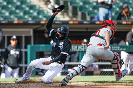 Apr 18, 2023; Chicago, Illinois, USA; Chicago White Sox center fielder Luis Robert Jr. (88) scores against Philadelphia Phillies catcher J.T. Realmuto (10) during the third inning of game one of the doubleheader at Guaranteed Rate Field. Mandatory Credit: Kamil Krzaczynski-Imagn Images