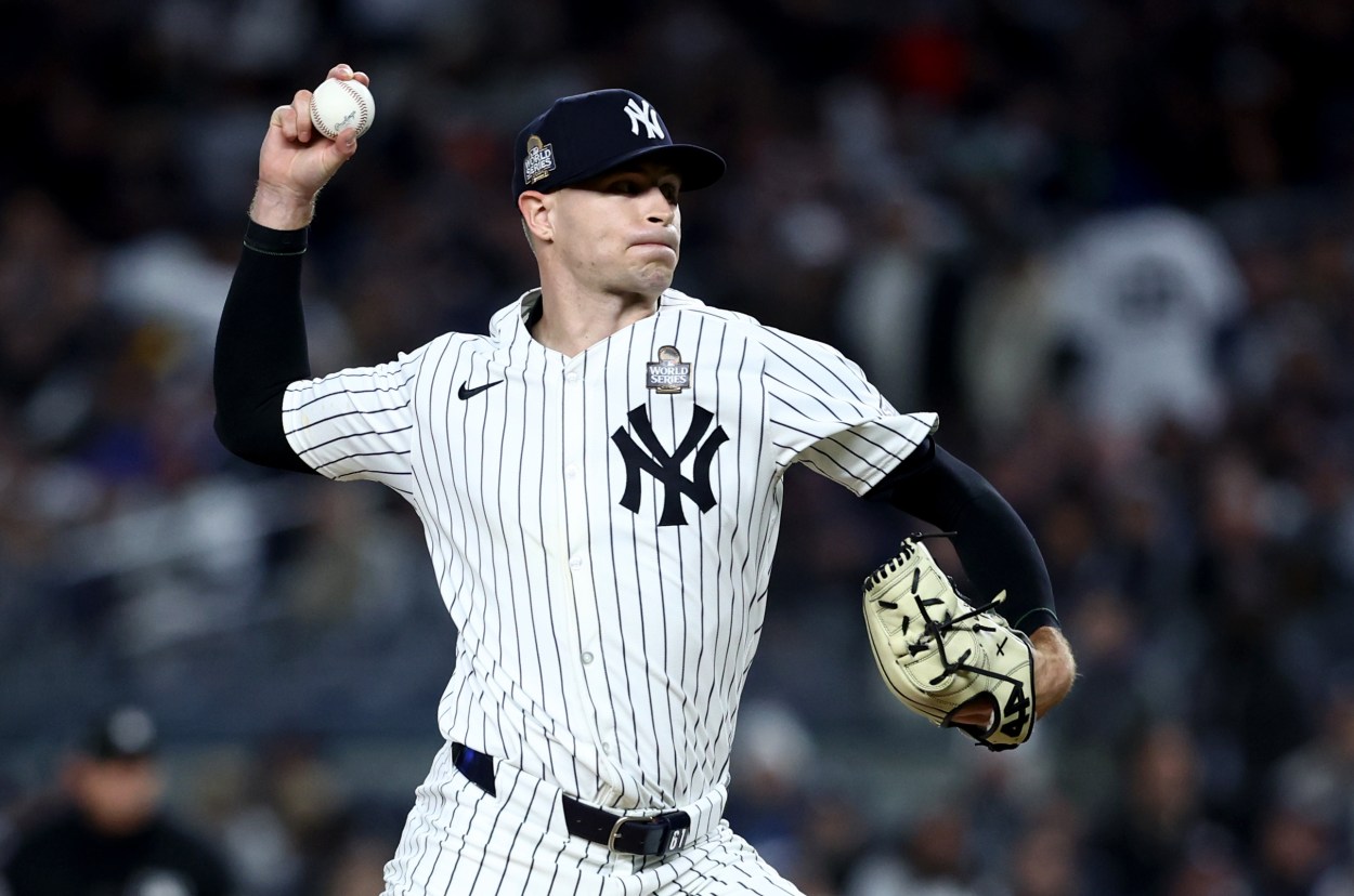 Oct 28, 2024; New York, New York, USA; New York Yankees pitcher Jake Cousins (61) throws during the sixth inning against the Los Angeles Dodgers in game three of the 2024 MLB World Series at Yankee Stadium. Mandatory Credit: Wendell Cruz-Imagn Images