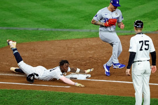 Oct 30, 2024; Bronx, New York, USA; New York Yankees third baseman Jazz Chisholm Jr. (13) dives into first base to try to beat the force out by Los Angeles Dodgers pitcher Michael Kopech (45) during the second inning during game five of the 2024 MLB World Series at Yankee Stadium. Mandatory Credit: James Lang-Imagn Images