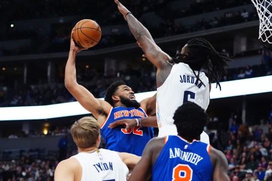 Nov 25, 2024; Denver, Colorado, USA; New York Knicks center Karl-Anthony Towns (32) drives at Denver Nuggets center DeAndre Jordan (6) in the second half at Ball Arena. Mandatory Credit: Ron Chenoy-Imagn Images