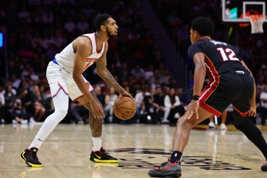 Oct 30, 2024; Miami, Florida, USA; New York Knicks guard Cameron Payne (1) dribbles the basketball as Miami Heat guard Dru Smith (12) defends during the third quarter at Kaseya Center. Mandatory Credit: Sam Navarro-Imagn Images