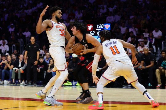 Oct 30, 2024; Miami, Florida, USA; Miami Heat guard Jaime Jaquez Jr. (11) protects the basketball against New York Knicks center Karl-Anthony Towns (32) during the second quarter at Kaseya Center. Mandatory Credit: Sam Navarro-Imagn Images