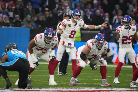 Nov 10, 2024; Munich, Germany; New York Giants quarterback Daniel Jones (8) prepares to take the snap against the Carolina Panthers in the first half during the 2024 NFL Munich Game at Allianz Arena. Mandatory Credit: Kirby Lee-Imagn Images