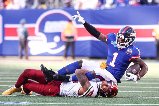 Nov 3, 2024; East Rutherford, New Jersey, USA; New York Giants wide receiver Malik Nabers (1) fights for a first down after a catch as Washington Commanders cornerback Benjamin St-Juste (25) tackles at MetLife Stadium. Mandatory Credit: Vincent Carchietta-Imagn Images