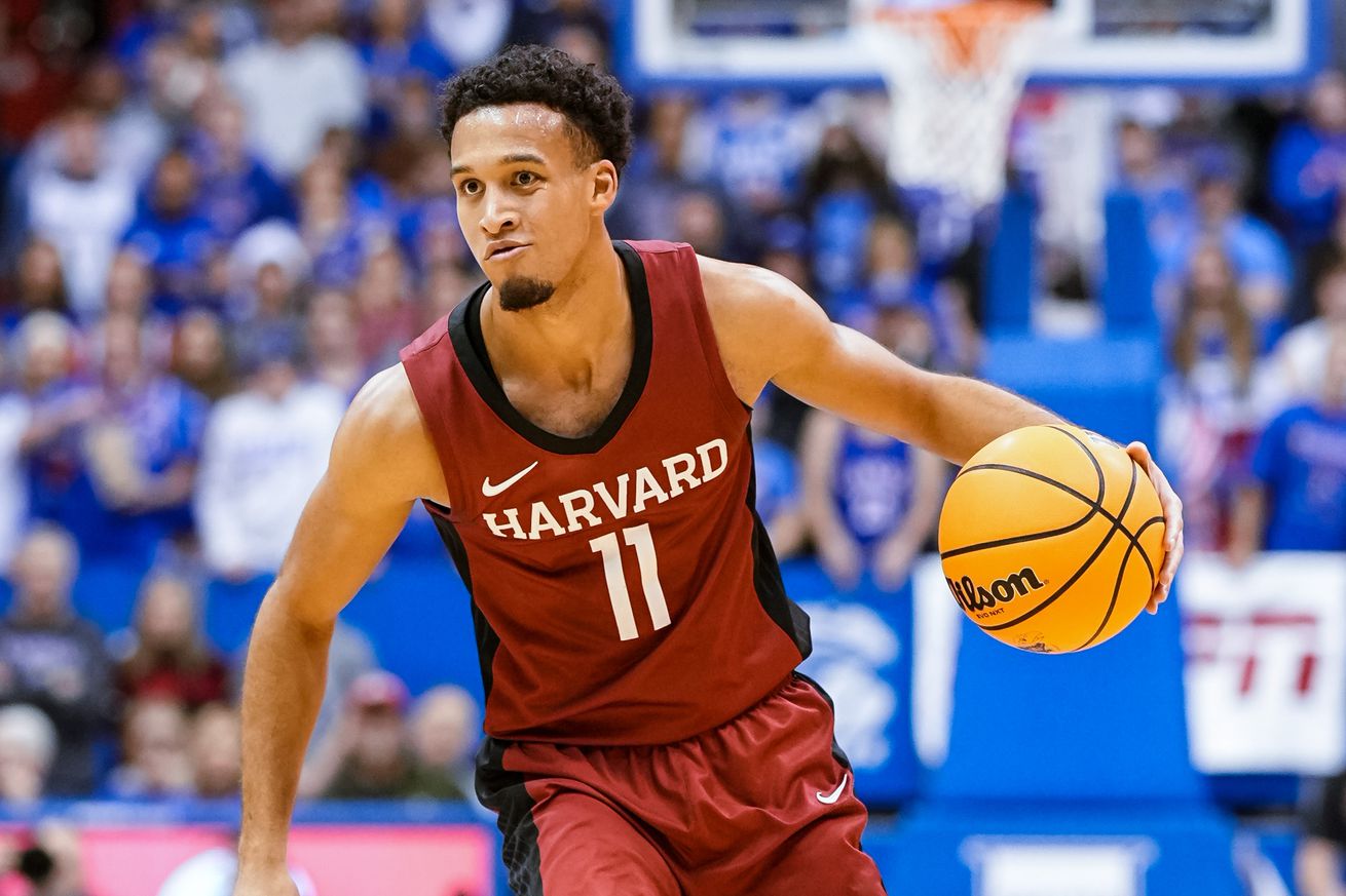 Dec 22, 2022; Lawrence, Kansas, USA; Harvard Crimson guard Evan Nelson (11) dribbles the ball during the first half against the Kansas Jayhawks at Allen Fieldhouse. Mandatory Credit: Jay Biggerstaff-Imagn Images