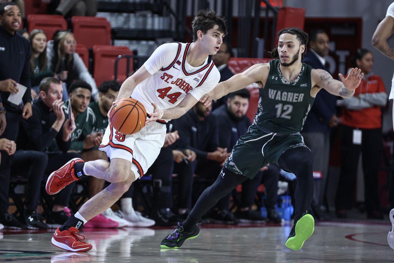 Nov 13, 2024; Queens, New York, USA; St. John’s Red Storm forward Brady Dunlap (44) looks to drive past Wagner Seahawks guard Zaire Williams (12) in the first half at Carnesecca Arena. Mandatory Credit: Wendell Cruz-Imagn Images