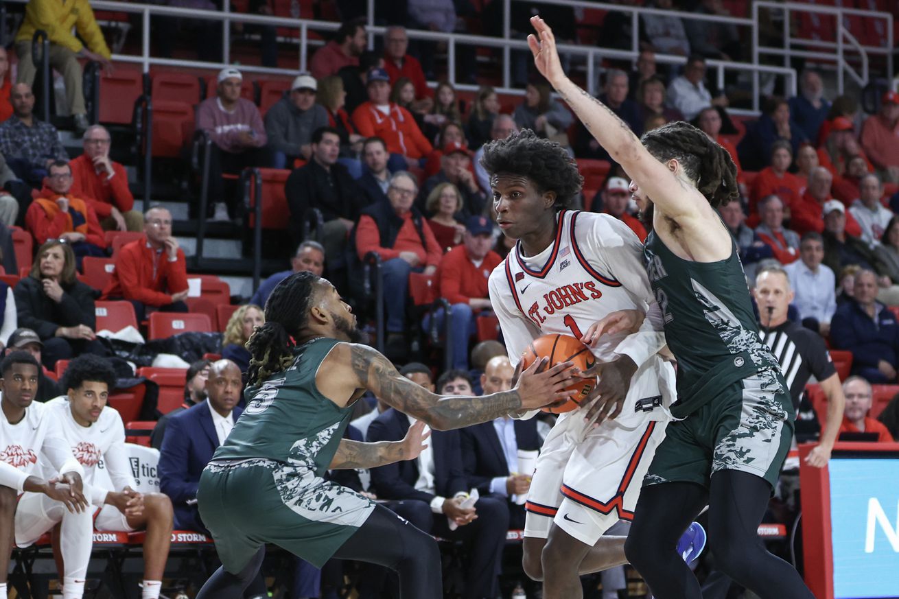 Nov 13, 2024; Queens, New York, USA; St. John’s Red Storm guard Kadary Richmond (1) looks to drive past Wagner Seahawks guards Zae Blake (5) and Zaire Williams (12) in the second half at Carnesecca Arena. Mandatory Credit: Wendell Cruz-Imagn Images