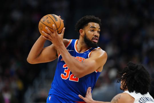 Nov 25, 2024; Denver, Colorado, USA; New York Knicks center Karl-Anthony Towns (32) controls the ball over Denver Nuggets guard Julian Strawther (3) in the second half at Ball Arena. Mandatory Credit: Ron Chenoy-Imagn Images