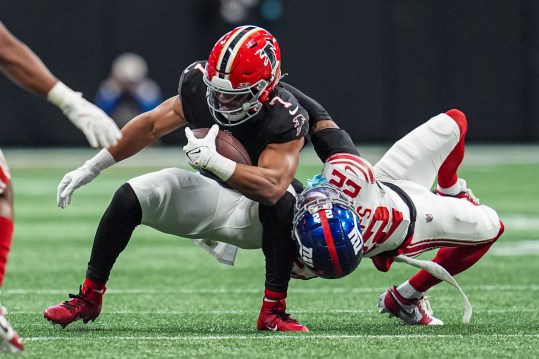 Dec 22, 2024; Atlanta, Georgia, USA; Atlanta Falcons running back Bijan Robinson (7) is tackled by New York Giants cornerback Dru Phillips (22) at Mercedes-Benz Stadium. Mandatory Credit: Dale Zanine-Imagn Images