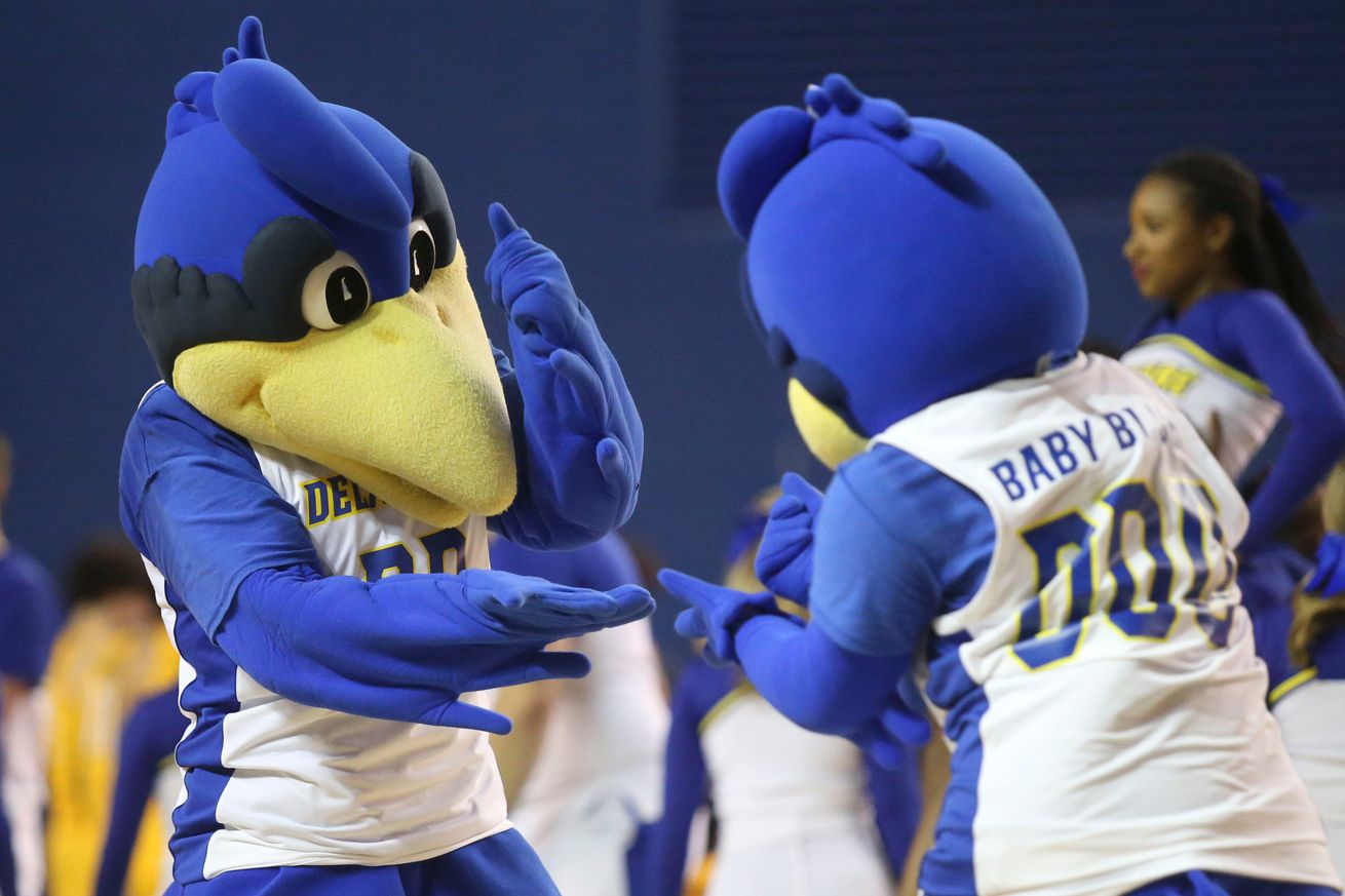 Youdee and Baby Blue come together in a timeout in the second half of Delaware’s 67-56 loss at the Bob Carpenter Center, Saturday, Jan. 27, 2024.