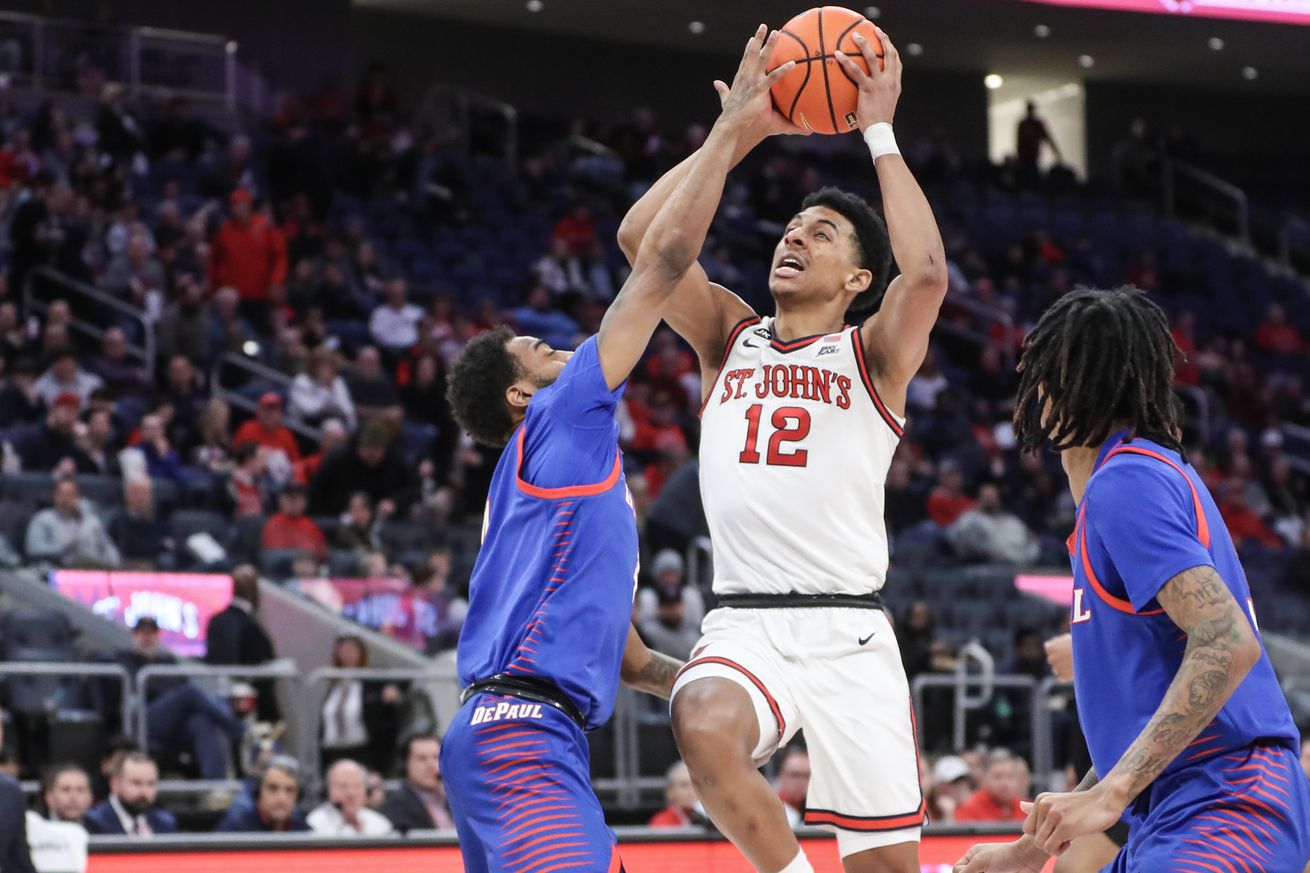 Feb 6, 2024; Elmont, New York, USA; St. John’s Red Storm guard RJ Luis Jr. (12) looks to drive past DePaul Blue Demons guard K.T. Raimey (4) in the second half at UBS Arena. Mandatory Credit: Wendell Cruz-Imagn Images