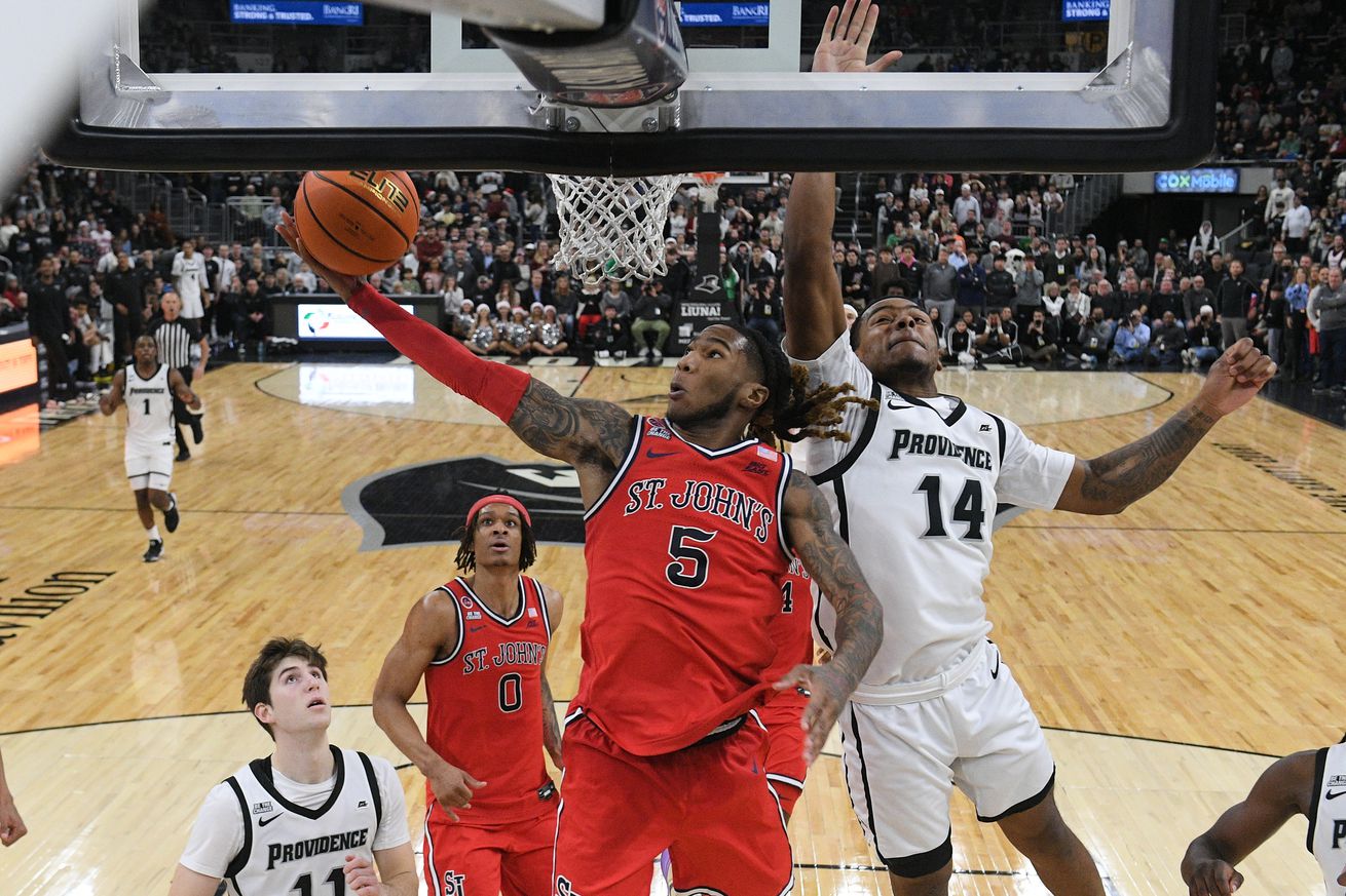 Dec 20, 2024; Providence, Rhode Island, USA; St. John’s Red Storm guard Deivon Smith (5) shoots a layup against Providence Friars guard Corey Floyd Jr. (14) during the second half at Amica Mutual Pavilion. Mandatory Credit: Eric Canha-Imagn Images