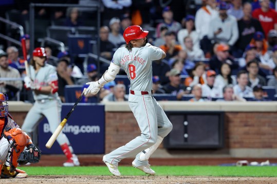 Oct 8, 2024; New York City, New York, USA; Philadelphia Phillies outfielder Nick Castellanos (8) hits an RBI single in the eighth inning against the New York Mets during game three of the NLDS for the 2024 MLB Playoffs at Citi Field. Mandatory Credit: Brad Penner-Imagn Images