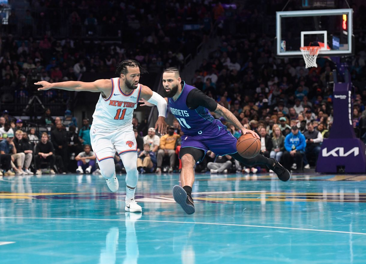 Nov 29, 2024; Charlotte, North Carolina, USA;  Charlotte Hornets forward Cody Martin (11) drives past New York Knicks guard Jalen Brunson (11) during the second half at the Spectrum Center. Mandatory Credit: Sam Sharpe-Imagn Images