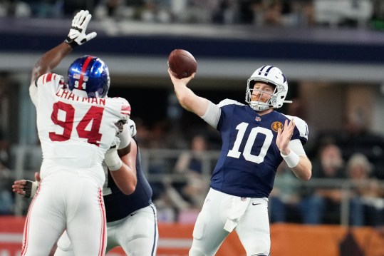 Nov 28, 2024; Arlington, Texas, USA;  Dallas Cowboys quarterback Cooper Rush (10) throws a pass as New York Giants defensive tackle Elijah Chatman (94) defends during the second half at AT&T Stadium. Mandatory Credit: Chris Jones-Imagn Images