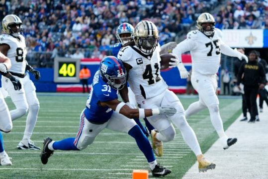 New Orleans Saints running back Alvin Kamara (41) had a pivatol run before being knocked out of bounds by New York Giants safety Tyler Nubin (31), Sunday, December 8, 2024, in East Rutherford. The run set the Saints upper the only touchdown of the first quarter.