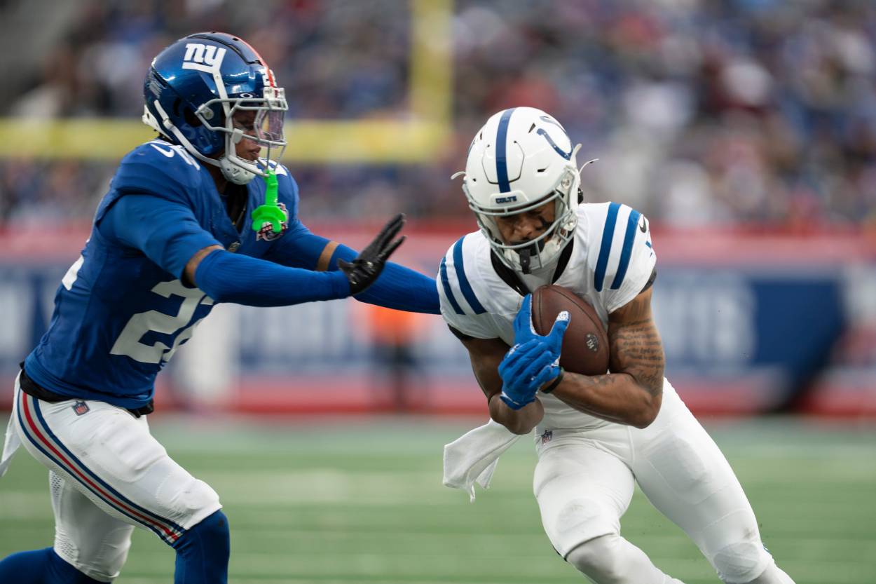 Indianapolis Colts wide receiver Josh Downs (1) runs with the ball before being pushed out of bounds by New York Giants cornerback Dru Phillips (22) during a game between New York Giants and Indianapolis Colts at MetLife Stadium on Sunday, Dec. 29, 2024.