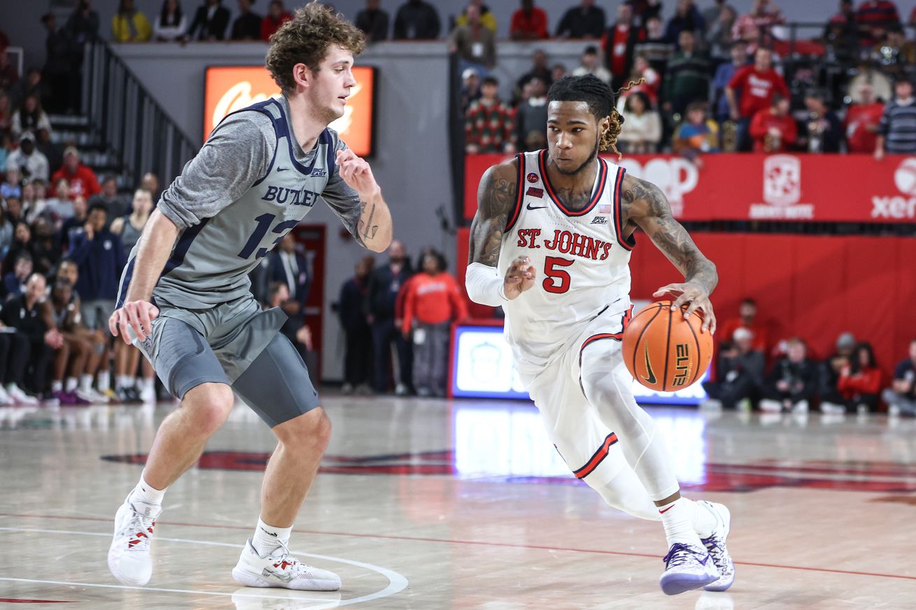 Queens, New York, USA; St. John’s Red Storm guard Deivon Smith (5) drives past Butler Bulldogs guard Finley Bizjack (13) in the second half at Carnesecca Arena. Mandatory Credit: Wendell Cruz-Imagn Images