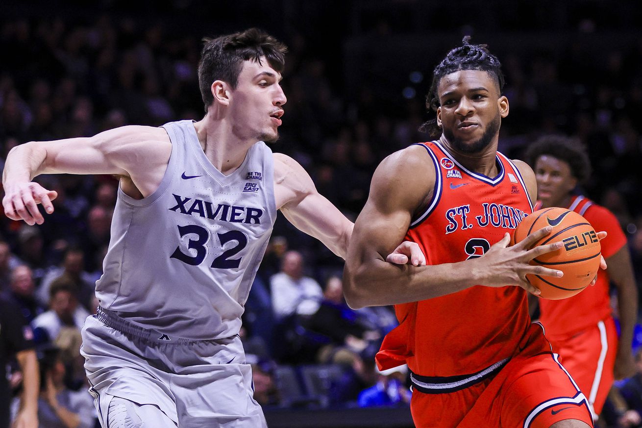 Jan 7, 2025; Cincinnati, Ohio, USA; St. John’s Red Storm forward Zuby Ejiofor (24) drives to the basket against Xavier Musketeers forward Zach Freemantle (32) in the second half at Cintas Center. Mandatory Credit: Katie Stratman-Imagn Images