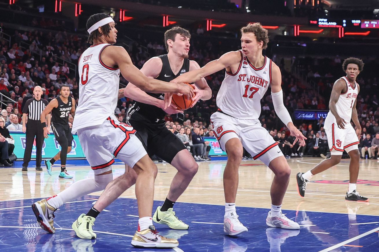 Jan 22, 2025; New York, New York, USA; Xavier Musketeers forward Zach Freemantle (32) is double-teamed by St. John’s Red Storm guard Aaron Scott (0) and forward Ruben Prey (17) in the first half at Madison Square Garden. Mandatory Credit: Wendell Cruz-Imagn Images