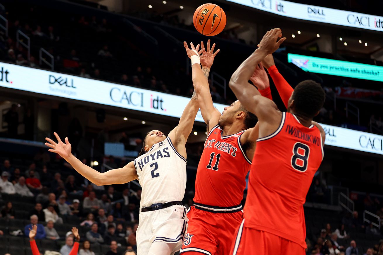 Jan 28, 2025; Washington, District of Columbia, USA; Georgetown Hoyas guard Malik Mack (2) takes a shot over St. John’s Red Storm guard Jaiden Glover (11) and St. John’s Red Storm center Vince Iwuchukwu (8) during the first half at Capital One Arena. Mandatory Credit: Daniel Kucin Jr.-Imagn Images