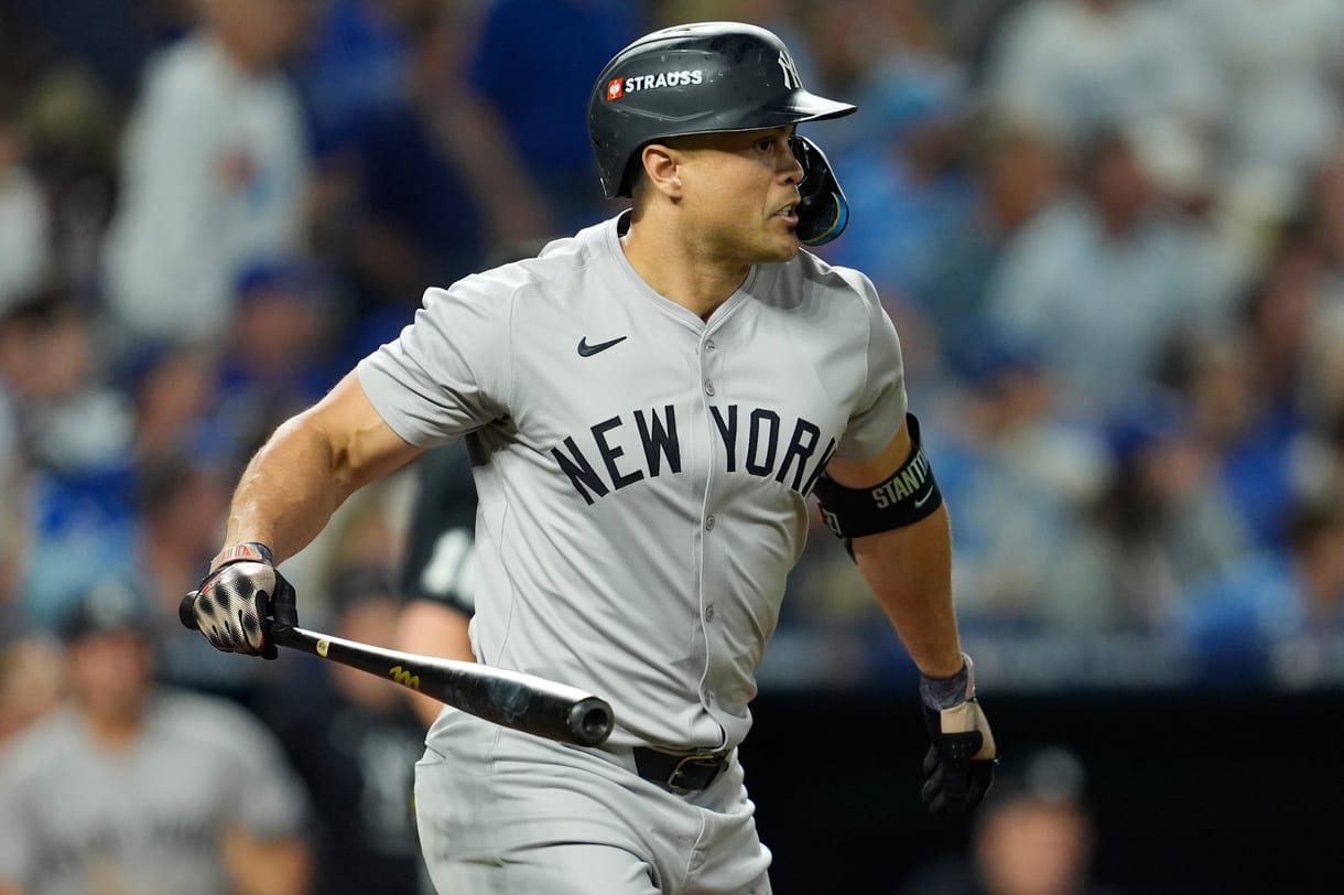 Oct 9, 2024; Kansas City, Missouri, USA; New York Yankees designated hitter Giancarlo Stanton (27) hits a home run in the eighth inning against the Kansas City Royals during game three of the NLDS for the 2024 MLB Playoffs at Kauffman Stadium. Mandatory Credit: Jay Biggerstaff -Imagn Images