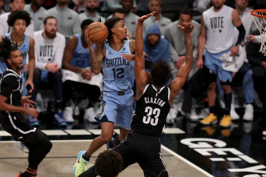 Nov 4, 2024; Brooklyn, New York, USA; Memphis Grizzlies guard Ja Morant (12) drives to the basket against Brooklyn Nets center Nic Claxton (33) during the fourth quarter at Barclays Center. Mandatory Credit: Brad Penner-Imagn Images