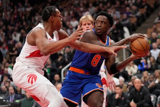 Dec 9, 2024; Toronto, Ontario, CAN; Toronto Raptors forward Scottie Barnes (4) defends against New York Knicks forward OG Anunoby (8) during the first half at Scotiabank Arena. Mandatory Credit: John E. Sokolowski-Imagn Images