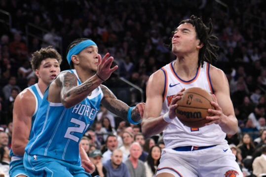 Oct 15, 2024; New York, New York, USA; New York Knicks guard Pacome Dadiet (4) drives to the basket while being defended by Charlotte Hornets guard Tre Mann (23) during the first half at Madison Square Garden. Mandatory Credit: John Jones-Imagn Images