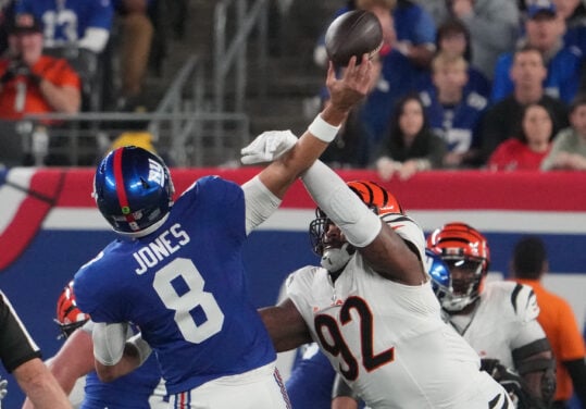 Oct 13, 2024; East Rutherford, New Jersey, USA;  Cincinnati Bengals defensive tackle B.J. Hill (92) forces an interception on a throw by New York Giants quarterback Daniel Jones (8) during the first quarter at MetLife Stadium. Mandatory Credit: Robert Deutsch-Imagn Images