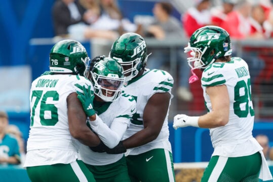 Dec 15, 2024; Jacksonville, Florida, USA; New York Jets wide receiver Garrett Wilson (5), offensive linebacker John Simpson (76), tight end Jeremy Ruckert (89), and offensive linebacker Olu Fashanu (74) celebrate a touchdown against the Jacksonville Jaguars during the first quarter at EverBank Stadium. Mandatory Credit: Morgan Tencza-Imagn Images