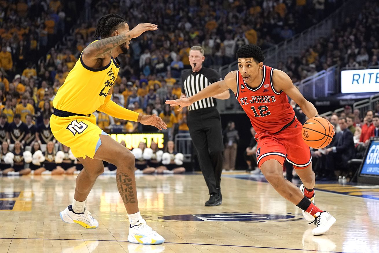 Feb 10, 2024; Milwaukee, Wisconsin, USA; St. John s Red Storm guard RJ Luis (12) drives for the base against Marquette Golden Eagles forward David Joplin (23) during the first half at Fiserv Forum. Mandatory Credit: Jeff Hanisch-Imagn Images