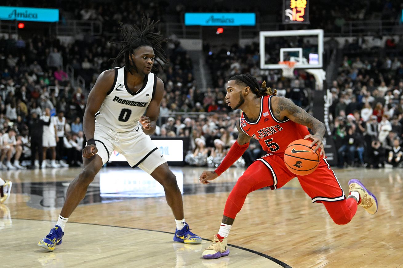 Dec 20, 2024; Providence, Rhode Island, USA; St. John’s Red Storm guard Deivon Smith (5) drives the ball against Providence Friars guard Wesley Cardet Jr. (0) during the second half at Amica Mutual Pavilion. Mandatory Credit: Eric Canha-Imagn Images