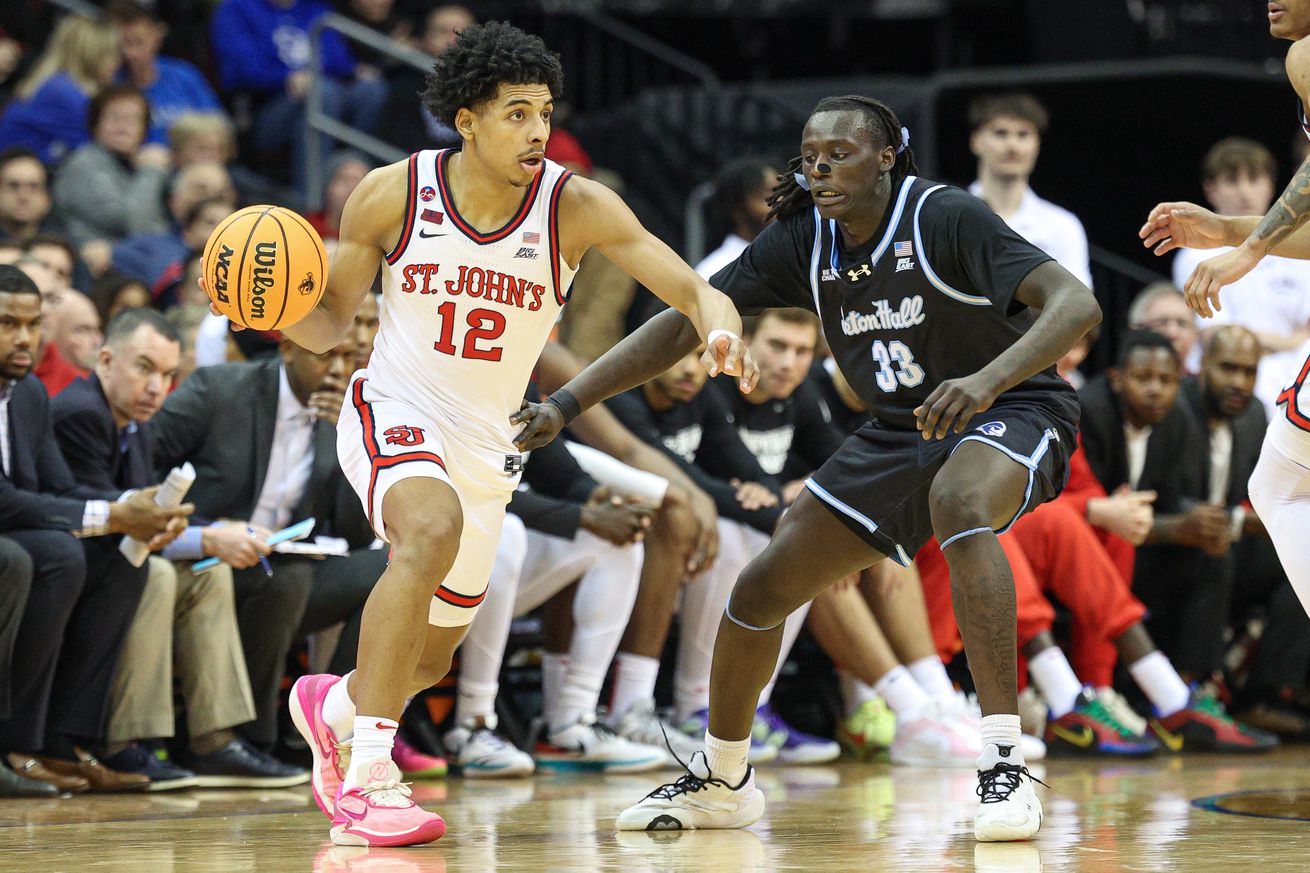 Jan 18, 2025; Newark, New Jersey, USA; St. John’s Red Storm guard RJ Luis Jr. (12) dribbles as Seton Hall Pirates guard Garwey Dual (33) defends during the second half at Prudential Center. Mandatory Credit: Vincent Carchietta-Imagn Images