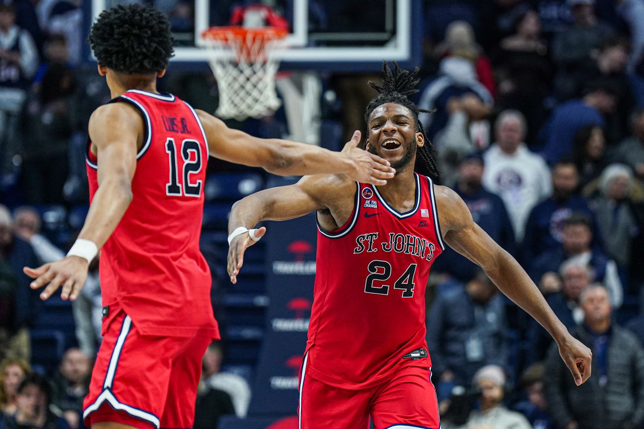 Feb 7, 2025; Storrs, Connecticut, USA;St. St. John’s Red Storm forward Zuby Ejiofor (24) and guard RJ Luis Jr. (12) react after defeating the UConn Huskies in the second half at Harry A. Gampel Pavilion. Mandatory Credit: David Butler II-Imagn Images