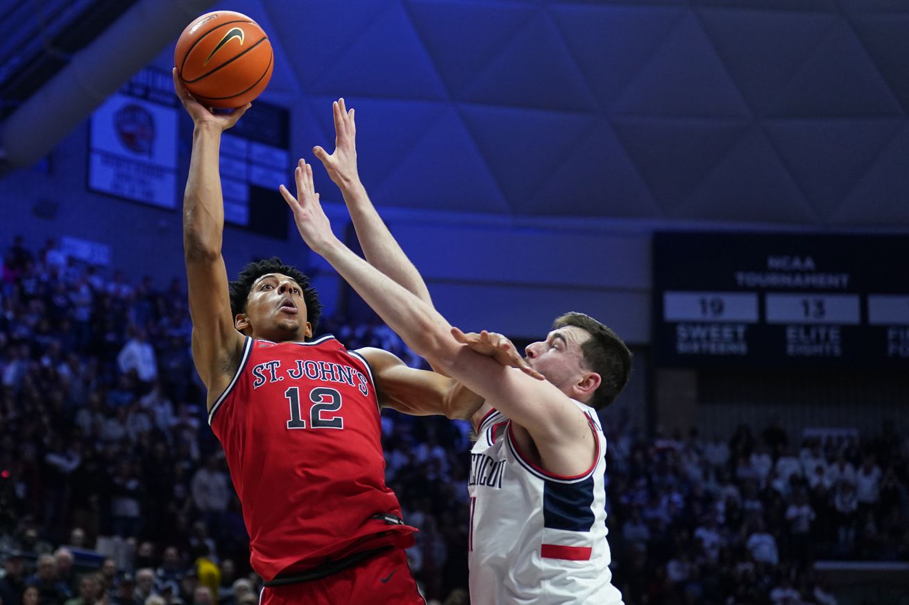 Feb 7, 2025; Storrs, Connecticut, USA; St. John’s Red Storm guard RJ Luis Jr. (12) shoots the ball against UConn Huskies forward Alex Karaban (11) in the second half at Harry A. Gampel Pavilion. Mandatory Credit: David Butler II-Imagn Images