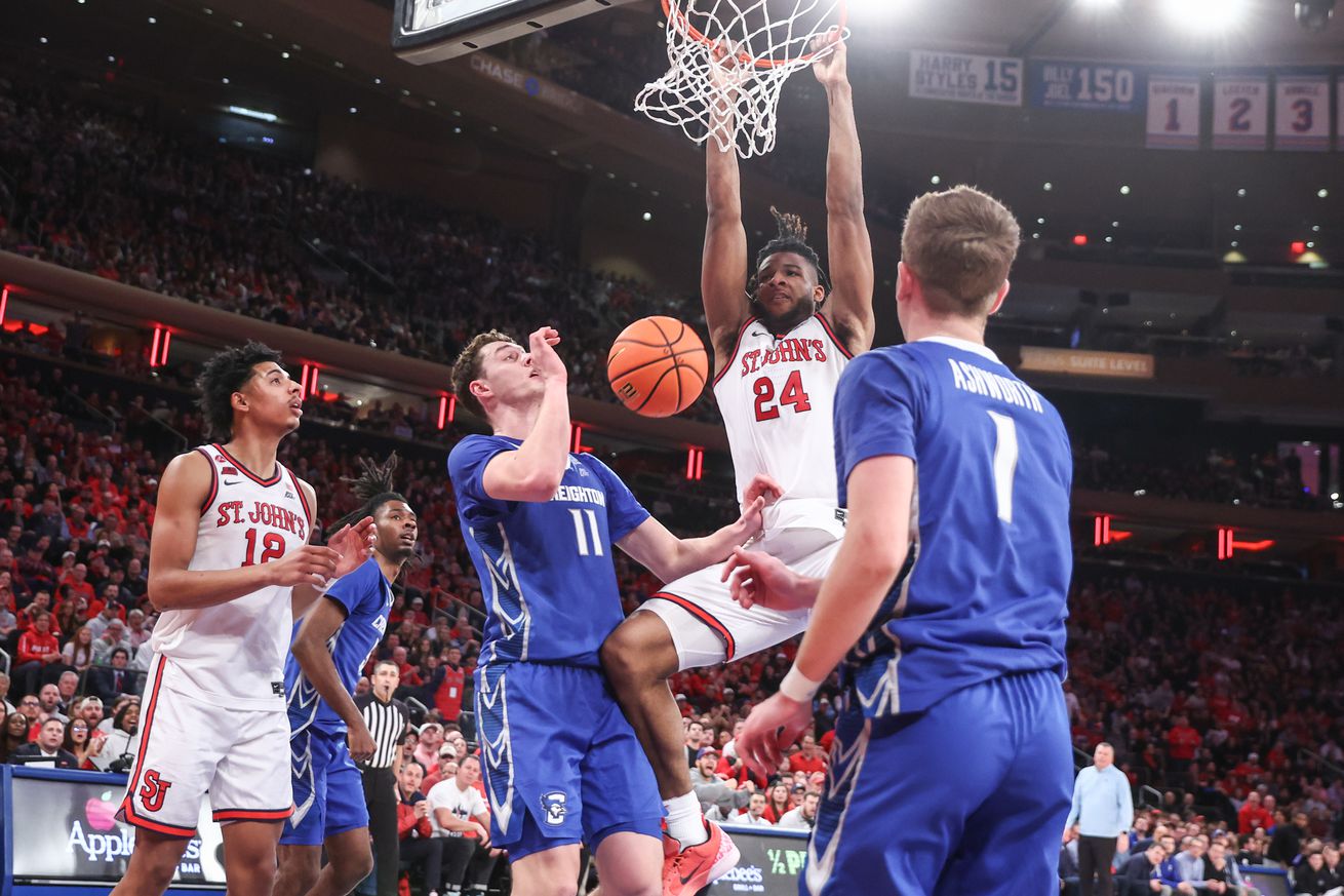 Feb 16, 2025; Queens, New York, USA; St. John’s Red Storm forward Zuby Ejiofor (24) dunks past Creighton Bluejays center Ryan Kalkbrenner (11) in the first half at Madison Square Garden. Mandatory Credit: Wendell Cruz-Imagn Images