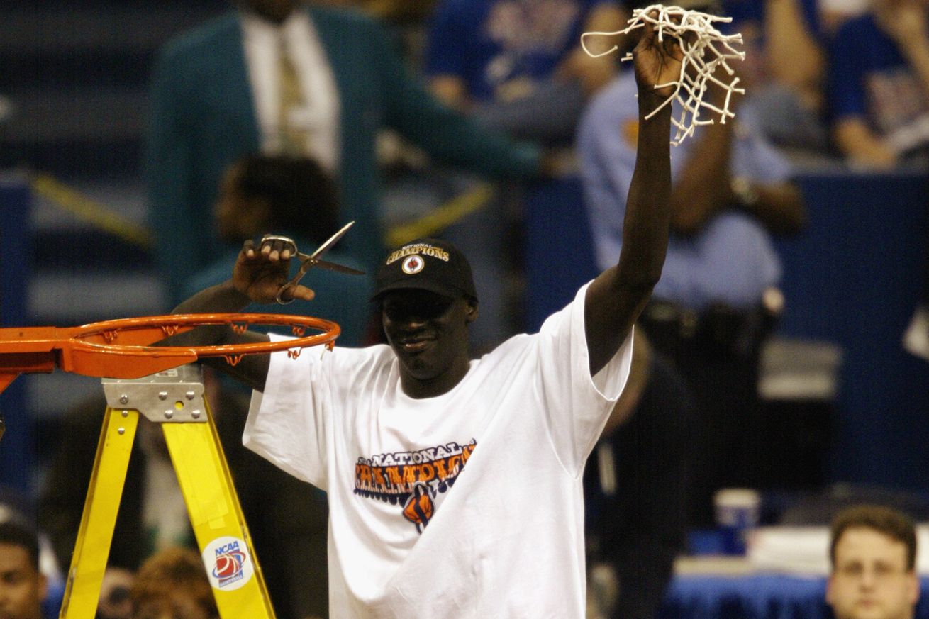 Kueth Duany holds the net in the air