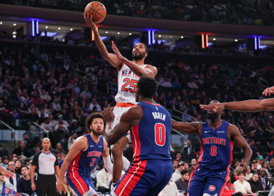 Dec 7, 2024; New York, New York, USA; New York Knicks forward Mikal Bridges (25) drives to the basket in front of Detroit Pistons forward Tim Hardaway Jr. (8) and center Jalen Duren (0) and guard Cade Cunningham (2) during the second half at Madison Square Garden. Mandatory Credit: Vincent Carchietta-Imagn Images